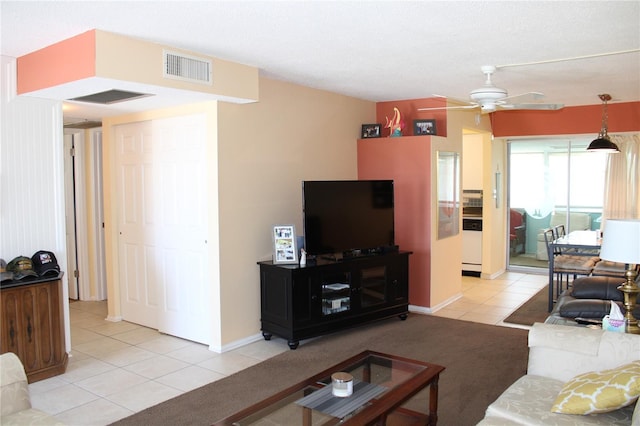 9950 47th Ave N Unit 311, Saint Petersburg, FL 33708 - living room with baseboards, visible vents, light tile patterned floors, and ceiling fan