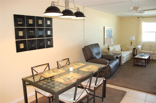 9950 47th Ave N Unit 311, Saint Petersburg, FL 33708 - dining area with light tile patterned floors and ceiling fan