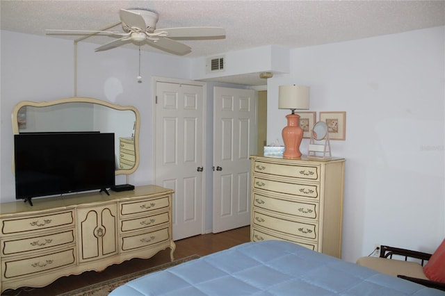 9950 47th Ave N Unit 311, Saint Petersburg, FL 33708 - bedroom with visible vents, wood finished floors, ceiling fan, and a textured ceiling