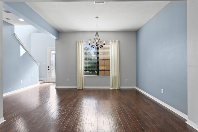 19407 Sweet Grass Way, Lutz, FL 33558 - unfurnished dining area featuring an inviting chandelier, hardwood / wood-style flooring, and baseboards