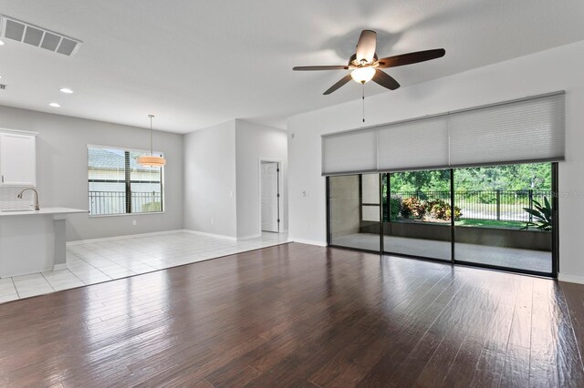 19407 Sweet Grass Way, Lutz, FL 33558 - unfurnished living room with recessed lighting, light wood-style floors, ceiling fan, baseboards, and visible vents