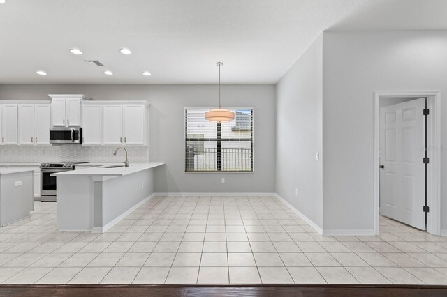 19407 Sweet Grass Way, Lutz, FL 33558 - kitchen featuring backsplash, a peninsula, light countertops, white cabinets, and appliances with stainless steel finishes