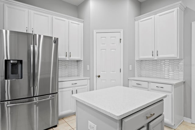 19407 Sweet Grass Way, Lutz, FL 33558 - kitchen featuring white cabinets, stainless steel fridge, and backsplash