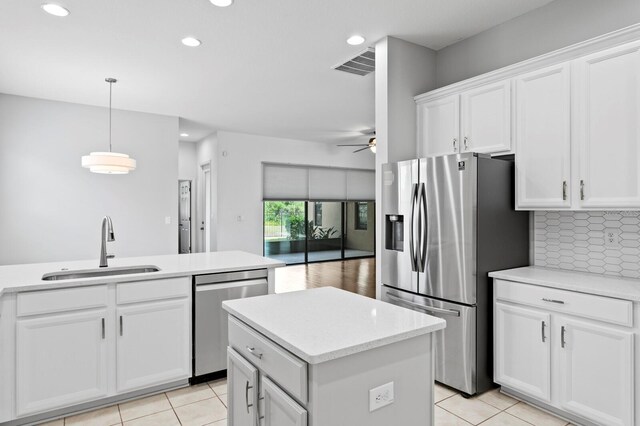 19407 Sweet Grass Way, Lutz, FL 33558 - kitchen featuring recessed lighting, stainless steel appliances, white cabinets, a sink, and a ceiling fan