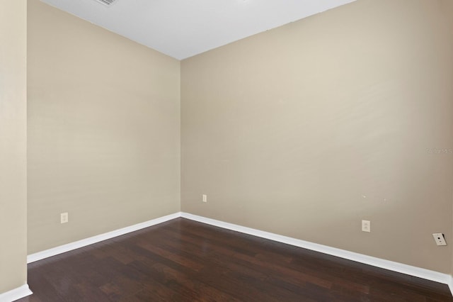 19407 Sweet Grass Way, Lutz, FL 33558 - empty room featuring dark wood-style flooring and baseboards