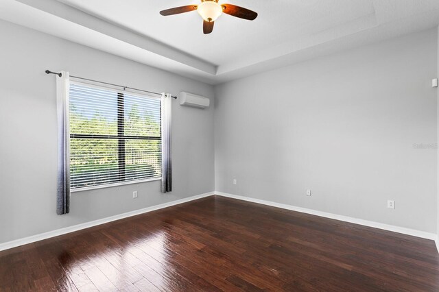 19407 Sweet Grass Way, Lutz, FL 33558 - spare room featuring hardwood / wood-style floors, baseboards, a wall unit AC, and a ceiling fan