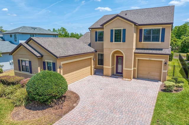 19407 Sweet Grass Way, Lutz, FL 33558 - view of front of home featuring fence, decorative driveway, a shingled roof, and stucco siding