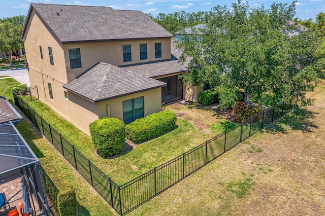 19407 Sweet Grass Way, Lutz, FL 33558 - view of side of home with fence private yard, a yard, a shingled roof, and stucco siding