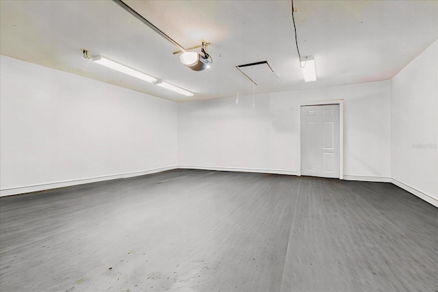 garage featuring baseboards and a garage door opener