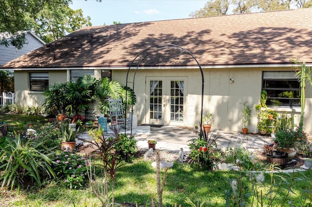 back of property featuring a patio area, roof with shingles, stucco siding, and french doors
