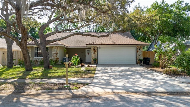 ranch-style house with driveway, roof with shingles, a garage, fence, and stone siding