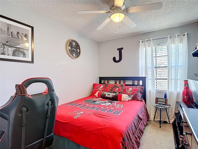 carpeted bedroom featuring ceiling fan and a textured ceiling