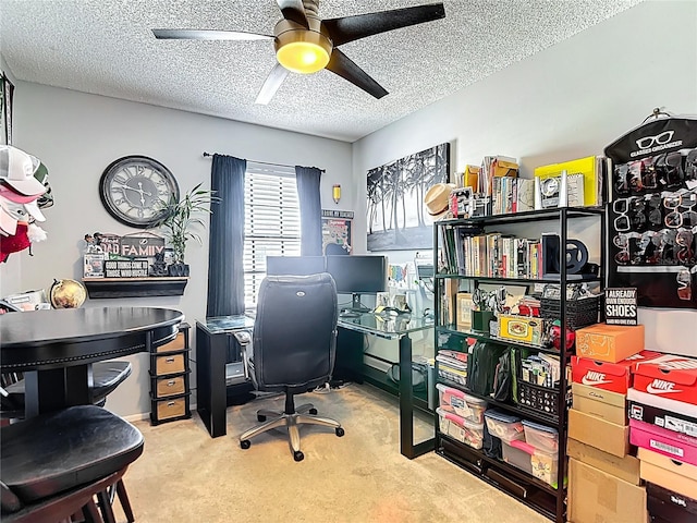 carpeted home office with a textured ceiling and a ceiling fan