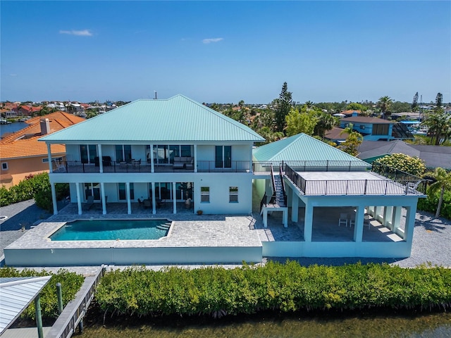 935 Chipaway Dr, Apollo Beach, FL 33572 - rear view of property featuring a balcony, a patio area, stairway, and an outdoor pool