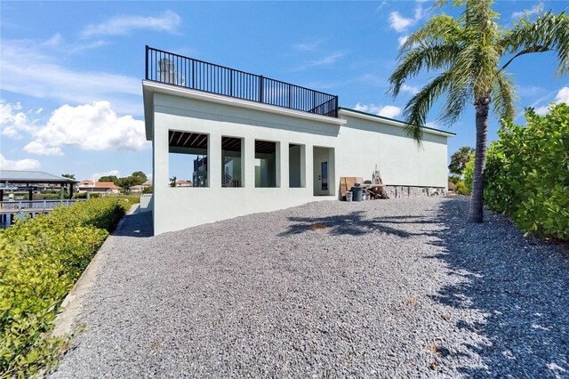 935 Chipaway Dr, Apollo Beach, FL 33572 - rear view of property featuring a balcony and stucco siding