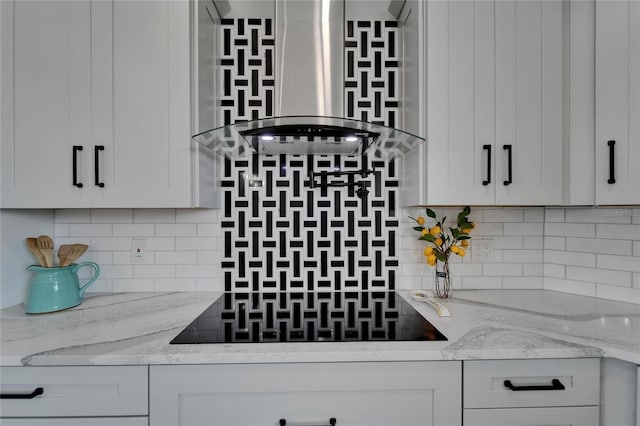 935 Chipaway Dr, Apollo Beach, FL 33572 - kitchen featuring wall chimney exhaust hood, backsplash, black electric stovetop, light stone counters, and white cabinetry