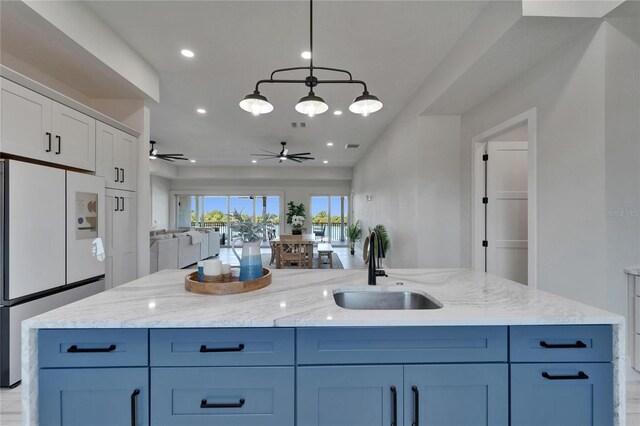 935 Chipaway Dr, Apollo Beach, FL 33572 - kitchen with freestanding refrigerator, a sink, ceiling fan, open floor plan, and recessed lighting