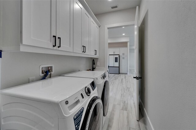 935 Chipaway Dr, Apollo Beach, FL 33572 - laundry area with washer and clothes dryer, cabinet space, light wood-style flooring, baseboards, and recessed lighting