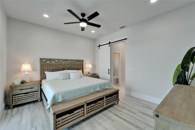 935 Chipaway Dr, Apollo Beach, FL 33572 - bedroom with a barn door, light wood finished floors, recessed lighting, baseboards, and a ceiling fan