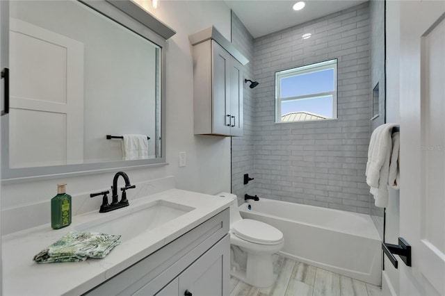935 Chipaway Dr, Apollo Beach, FL 33572 - bathroom featuring toilet, vanity, tub / shower combination, and wood finished floors