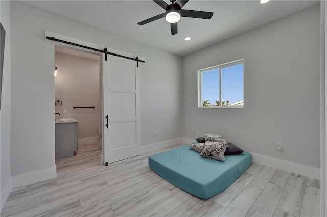 935 Chipaway Dr, Apollo Beach, FL 33572 - sitting room with a barn door, ceiling fan, baseboards, light wood-style floors, and recessed lighting