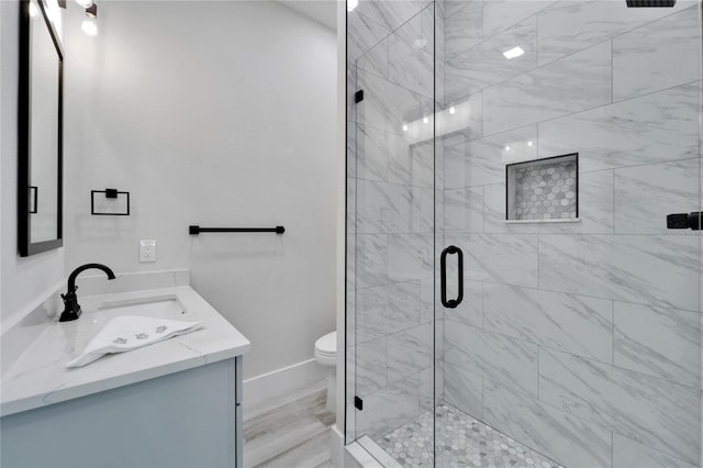 935 Chipaway Dr, Apollo Beach, FL 33572 - full bathroom featuring a stall shower, baseboards, vanity, and toilet