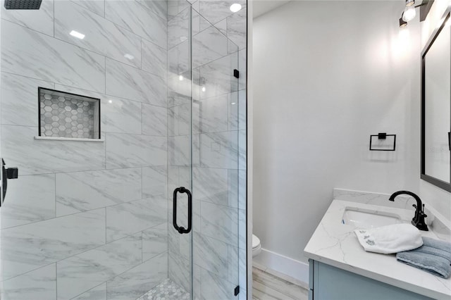 935 Chipaway Dr, Apollo Beach, FL 33572 - bathroom featuring a stall shower, vanity, toilet, and baseboards