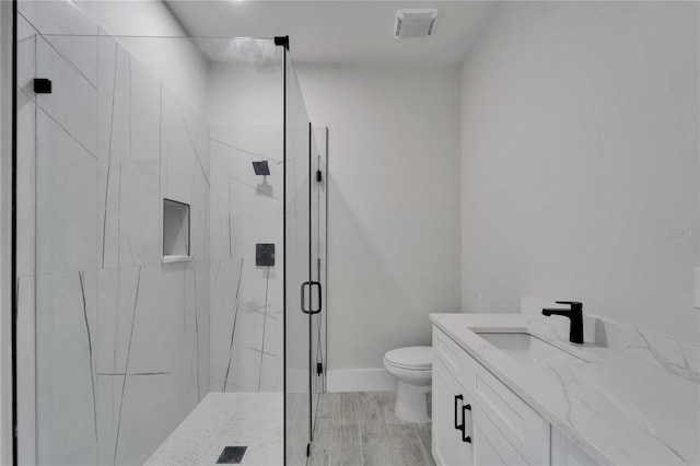 935 Chipaway Dr, Apollo Beach, FL 33572 - bathroom featuring a marble finish shower, toilet, vanity, and baseboards