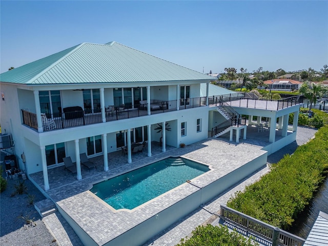 935 Chipaway Dr, Apollo Beach, FL 33572 - back of property featuring a ceiling fan, a balcony, stucco siding, and stairway