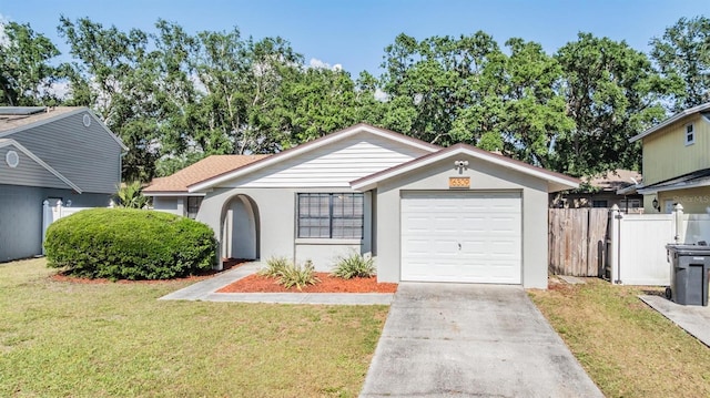 single story home featuring a garage, a front lawn, fence, stucco siding, and concrete driveway