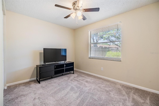 carpeted bedroom with baseboards, a textured ceiling, and ceiling fan