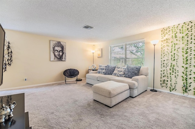 living room featuring visible vents, a textured ceiling, carpet, and baseboards