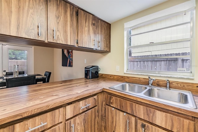 kitchen featuring a sink, brown cabinetry, and butcher block countertops