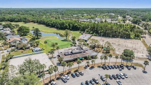 aerial view featuring a water view, a view of trees, and golf course view