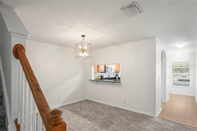 dining area with visible vents, arched walkways, baseboards, and light carpet