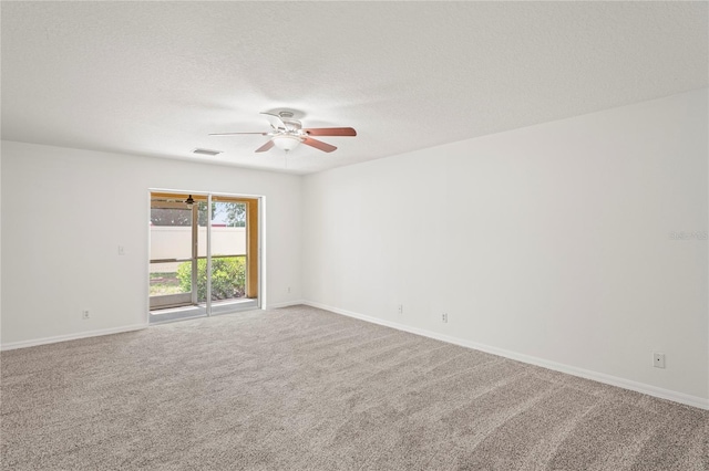 empty room featuring baseboards, ceiling fan, carpet, and visible vents