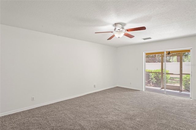 empty room with carpet floors, baseboards, a ceiling fan, and visible vents
