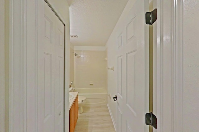 full bathroom featuring visible vents, vanity, toilet, shower / tub combination, and a textured ceiling