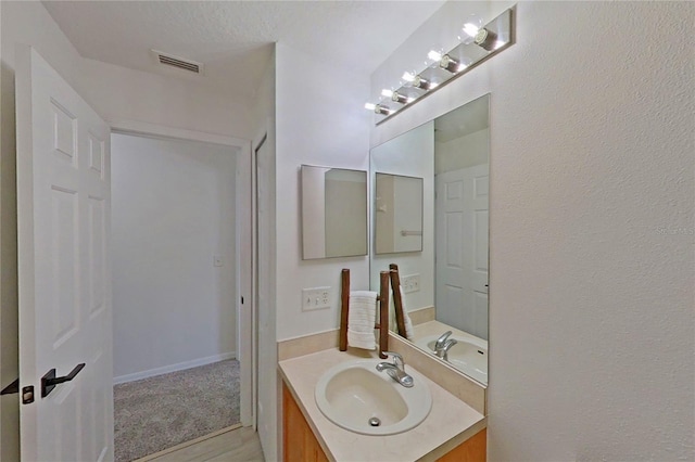 bathroom featuring visible vents and vanity