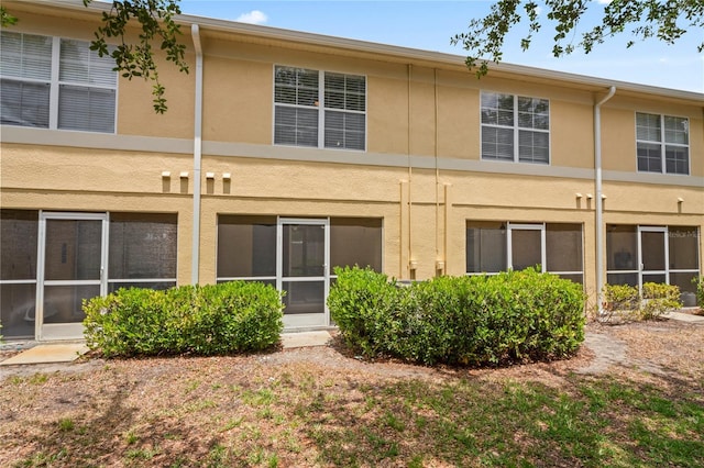 rear view of property with stucco siding