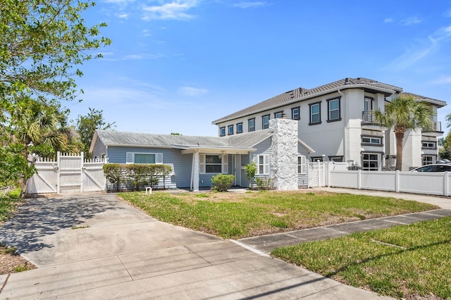 traditional-style home with fence, a gate, and a front yard