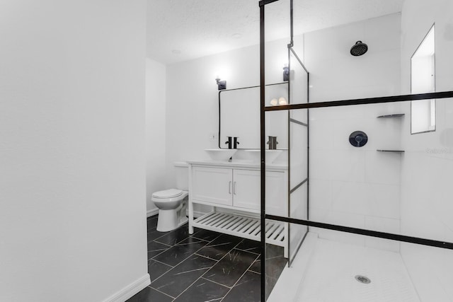 full bathroom featuring toilet, vanity, marble finish floor, and tiled shower