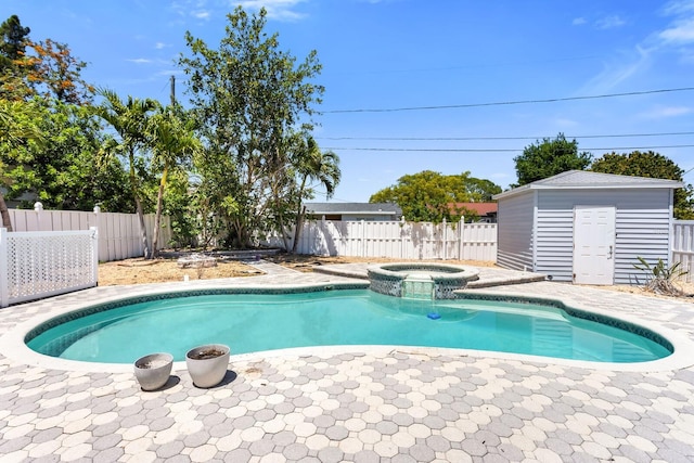 view of pool with an outdoor structure, a storage unit, and a fenced backyard