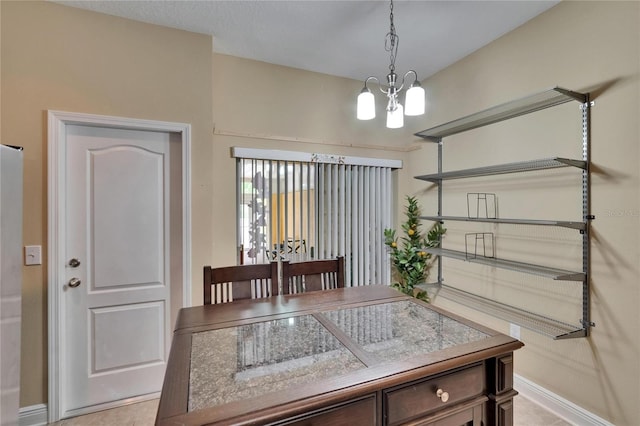 dining space with baseboards and a notable chandelier