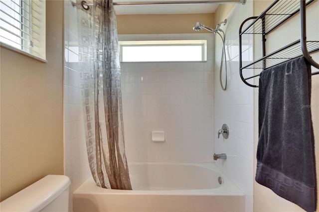 full bath featuring toilet and shower / bathtub combination with curtain