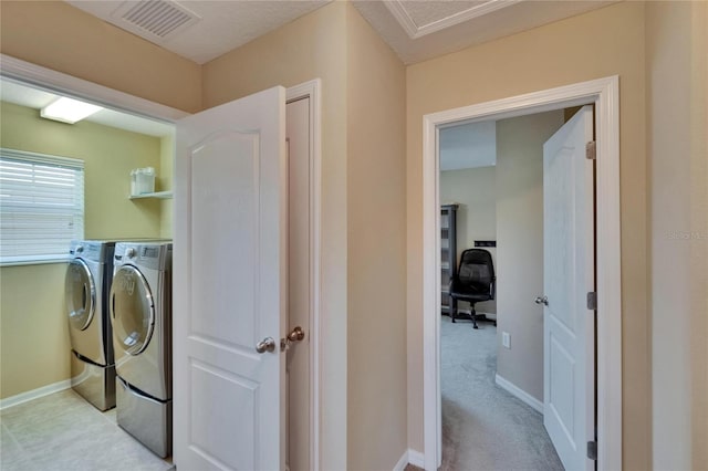 laundry area featuring separate washer and dryer, baseboards, laundry area, and visible vents