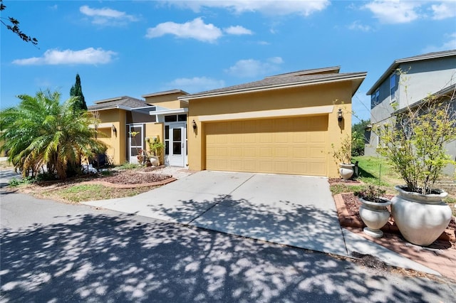 view of front of house featuring a garage, stucco siding, and driveway