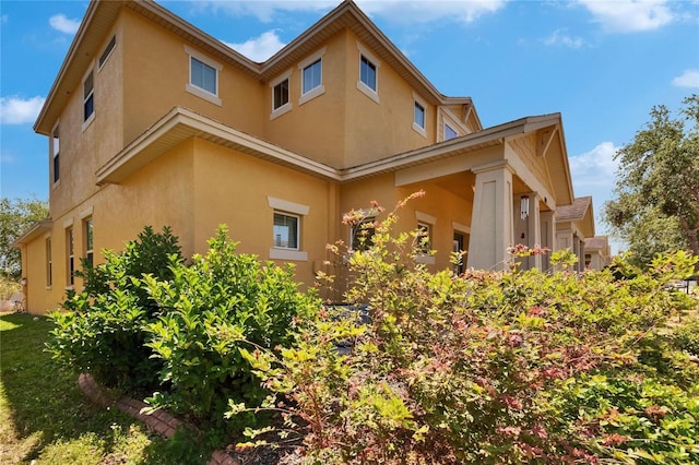 view of side of property with stucco siding