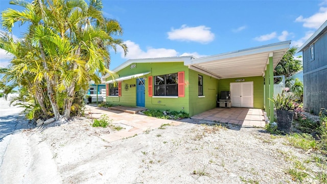 121 86th Ter, Treasure Island, FL 33706 - view of front of property with concrete block siding and a carport