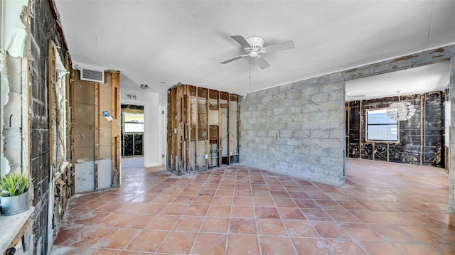 121 86th Ter, Treasure Island, FL 33706 - tiled spare room featuring a ceiling fan and a textured ceiling